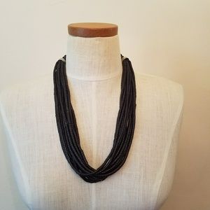 Bib boho multi-strand black wood bead necklace.